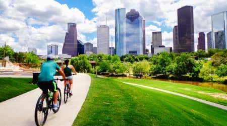 Couple biking at Buffalo Bayou Park