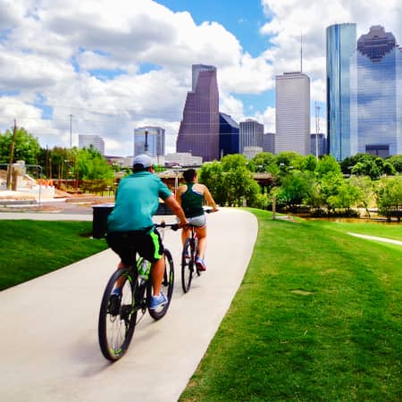 Couple biking at Buffalo Bayou Park