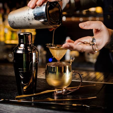 Cocktail being poured at a speakeasy