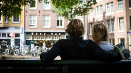 Couple people watching on a bench