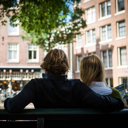 Couple people watching on a bench