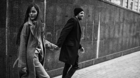 Couple holding hands in urban environment