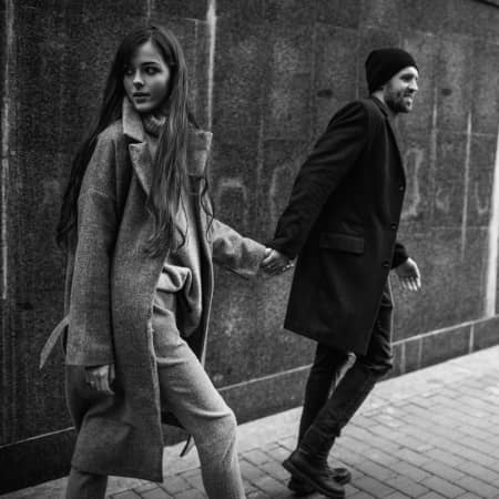 Couple holding hands in urban environment