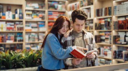 Couple examining a book in a bookstore