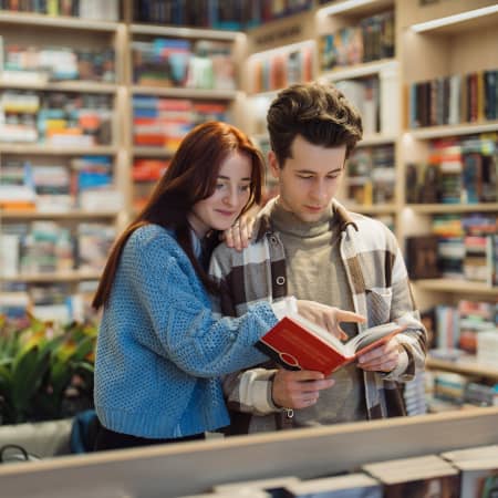 Couple examining a book in a bookstore