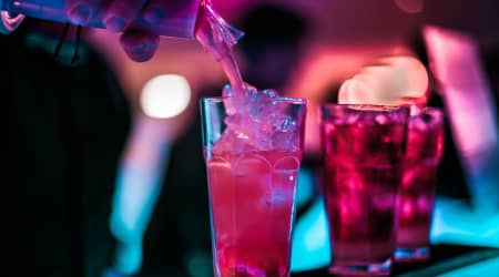 Drink being poured colored with neon lighting