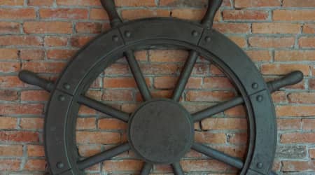 Ship wheel on a brick wall