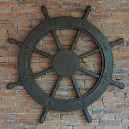Ship wheel on a brick wall