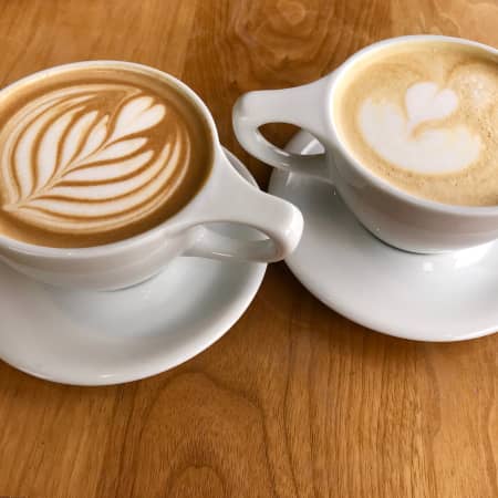 Heart-shaped latte art on two cups